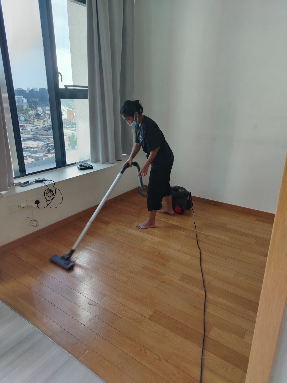Hiremop professional vacuuming a wooden floor